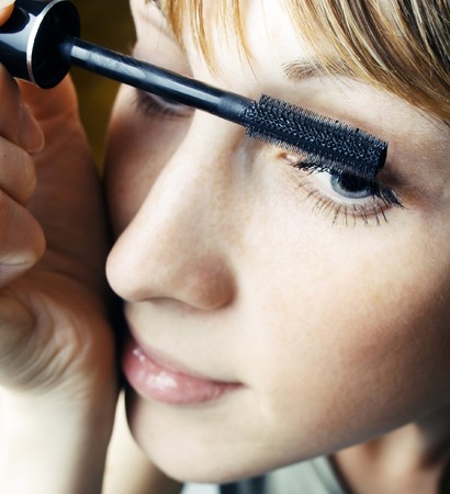 Young woman doing make upの写真素材