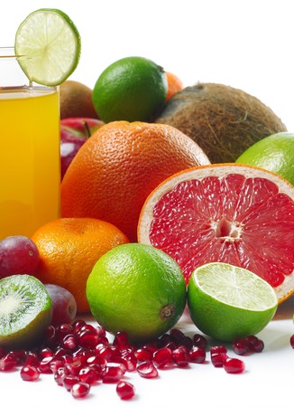 Fruits and slices near glass with juiceの写真素材