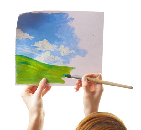Hands with brush and paper with imageの写真素材