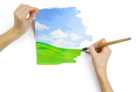 Hands with brush and paper with imageの写真素材