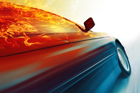 Sport car with burning roof in motion on icy roadの写真素材