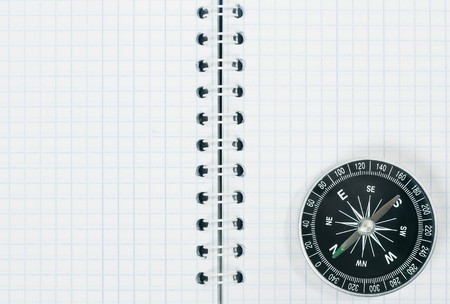 Compass on white blank notebookの写真素材