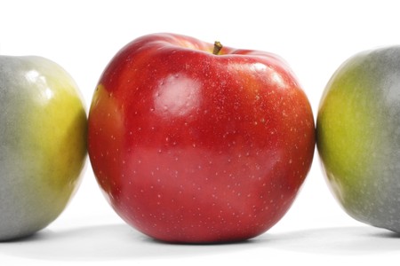 Red apple influencing to near green applesの写真素材