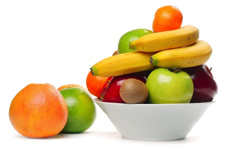 Fruits in deep plate over whiteの写真素材