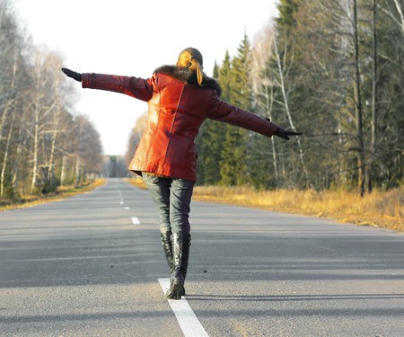 Alone woman walking on roadの写真素材