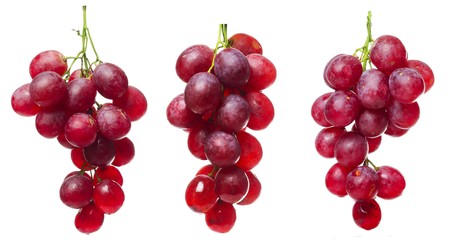 Purple grape bunches with green stems isolated on whiteの写真素材