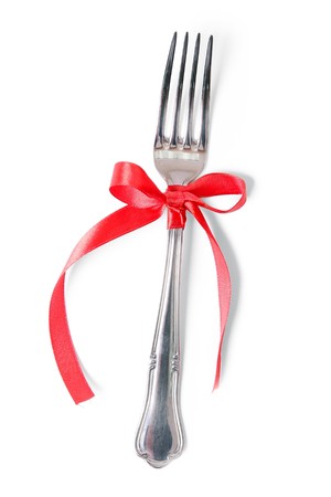 Fork with red ribbon over whiteの写真素材