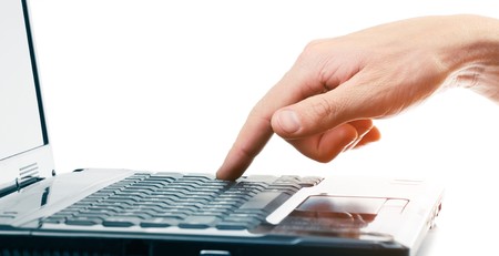 Hand above computer keyboardの写真素材