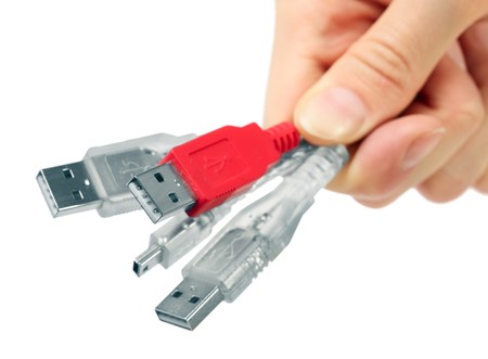 Hand with usb wires. Focus on red. Small DOFの写真素材