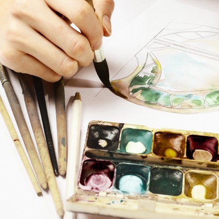 Hand with brush and paintの写真素材