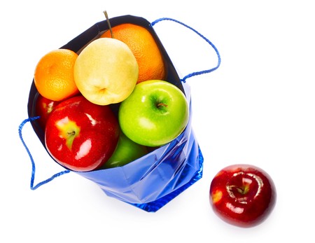 Shopping bag with fruits over whiteの写真素材