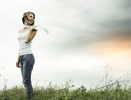 Woung woman with white ribbon over cloudy sky backgroundの写真素材