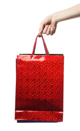 Hand holding a red bag over whiteの写真素材