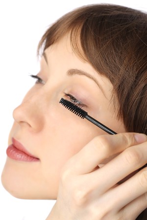 Young woman doing make-upの写真素材