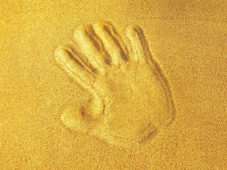 Hand print on beach sandの写真素材