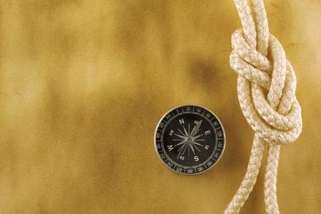 Compass with rope on acient paperの写真素材