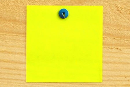 Blank paper reminder fixed on wood surface