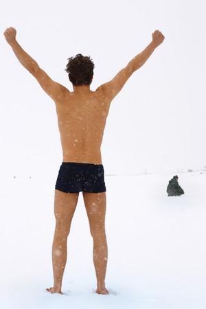 Naked men on snow surfaceの写真素材