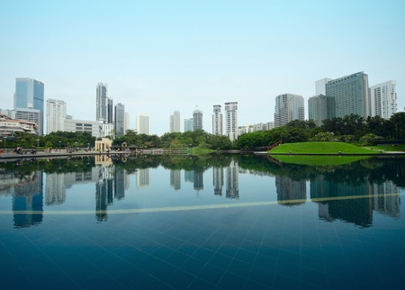 Buildings of a city with reflection in water. Kuala Lumpurの写真素材