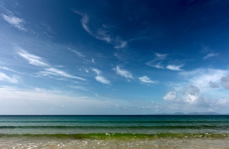 Blue sea with waves and sky with cloudsの写真素材