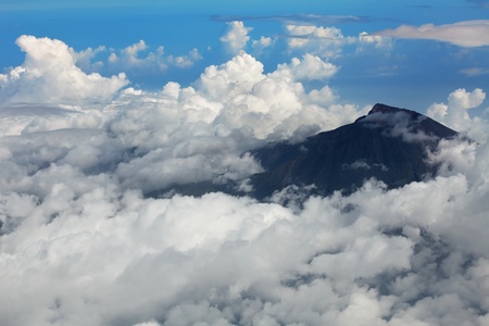 Mountain Rinjani among clouds. View frome plane. Lombok island. Indonesiaの写真素材