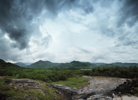 Rocky land and mountains on a horizonの写真素材