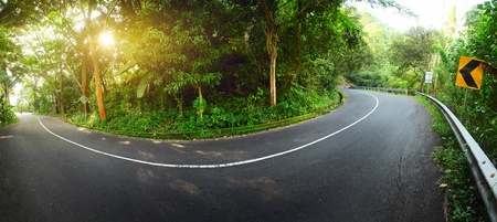 Asphalt road in mountains. Panorama at sunrise lightの写真素材