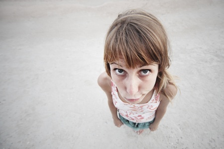 Young pity woman with big eyes and grimace on faceの写真素材