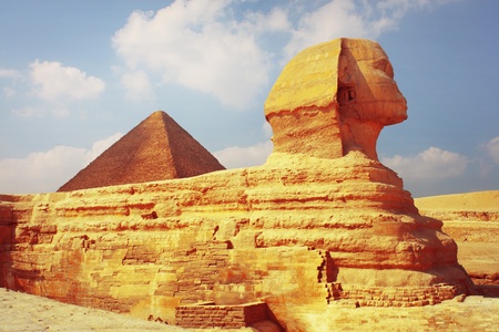 Sphinx statue and pyramid of Cheops on the background. Giza plateau in Egyptの写真素材