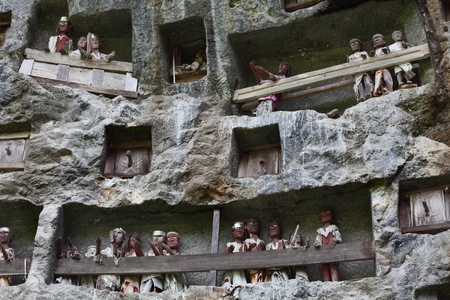 Traditional statues tau tau on a rock wall. Toraja region of Sulawesi island. Indonesiaの写真素材