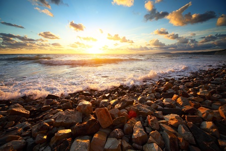 Group of rocks on a sea coast at sunsetの写真素材