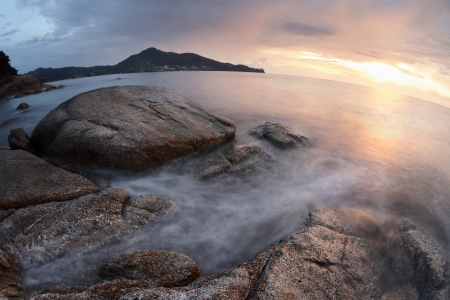 Rocky coast of Andaman sea near Laem Sing beach at sunset light. Phuket, Thailandの写真素材
