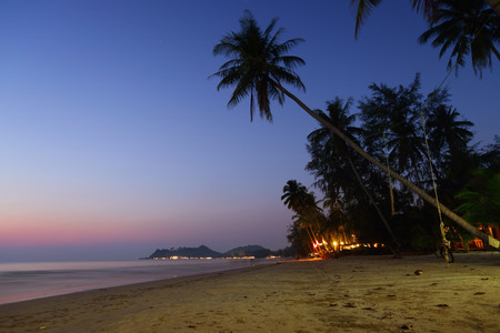 Tropical beach with palm trees at twilight. Thailandの写真素材
