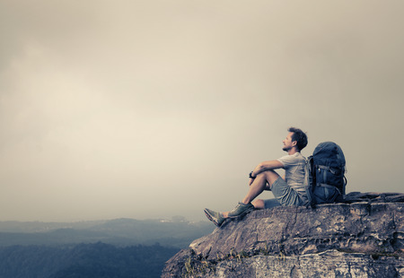 Hiker relaxing on top of the mountainの写真素材