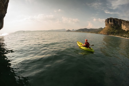 Young lady paddling the kayakの写真素材