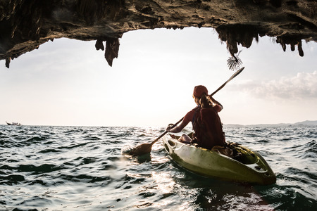 Young lady paddling the kayakの写真素材