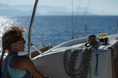 Young woman relaxing on the sail boatの写真素材