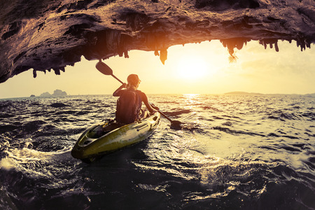 Lady paddling the kayak in the rough seaの写真素材