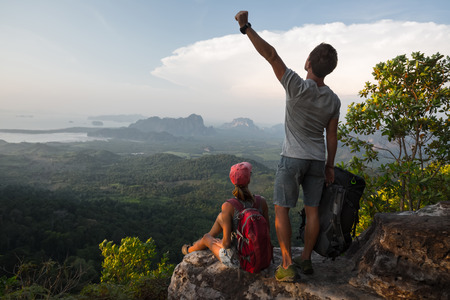 Couple of hikers relaxing on top of the mountainの写真素材