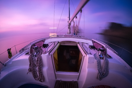 Yacht anchored in open sea at twilight