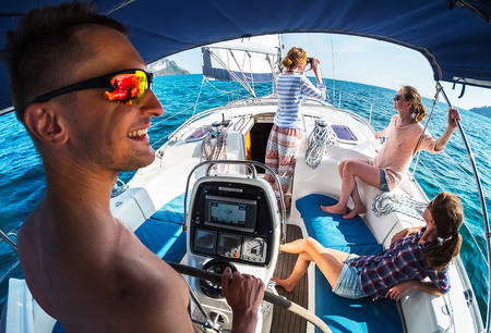 Crew of young friends sailing in a blue sea on the yacht