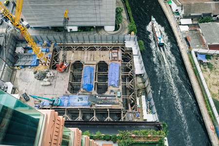 Construction of the office building near small river in Bangkok