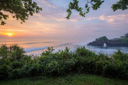 Sunset in the ocean at the Tanah Lot Temple, Bali, Indonesiaの写真素材