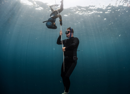 Free diver performing warm up dive - static apnea on the depthの写真素材