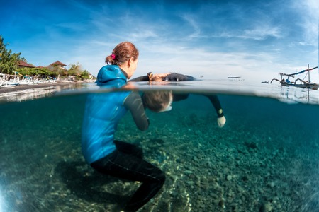 Underwater shot of free divers training in low water in the tropical sea, Amed, Indonesiaの写真素材