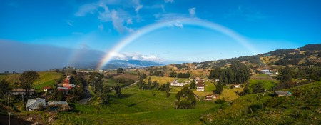 Green meadows and rainbow. View from slope of volcano of Irazu to the valley. Costa Ricaの写真素材