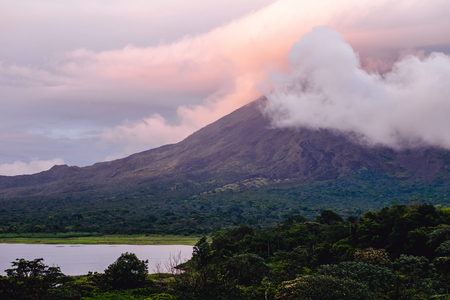 Volcano of Arenal covered in clouds at sunrise. Costa Rica