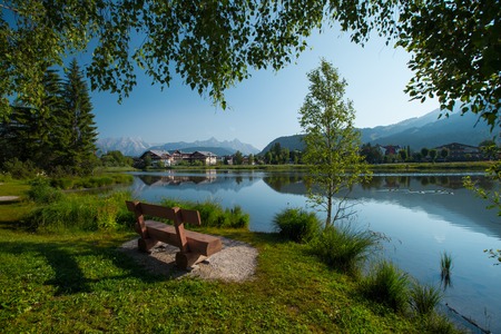 Pond in Alps with clear still water surface and swimming ducks. Seefeld, Austriaの写真素材
