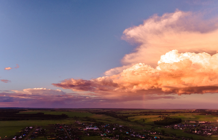 Aerial view of russian village with clouds in the sky during sunsetの写真素材
