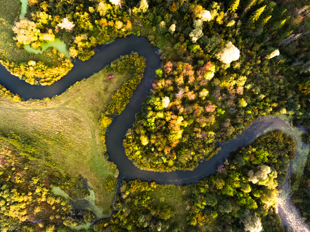 Aerial view of the autumn forest and small riverの写真素材